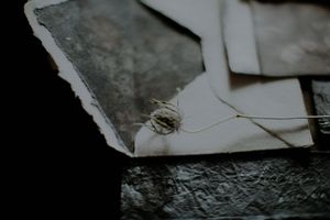 Abstract black and white photograph showing fragmented shapes and textures with stark contrast.