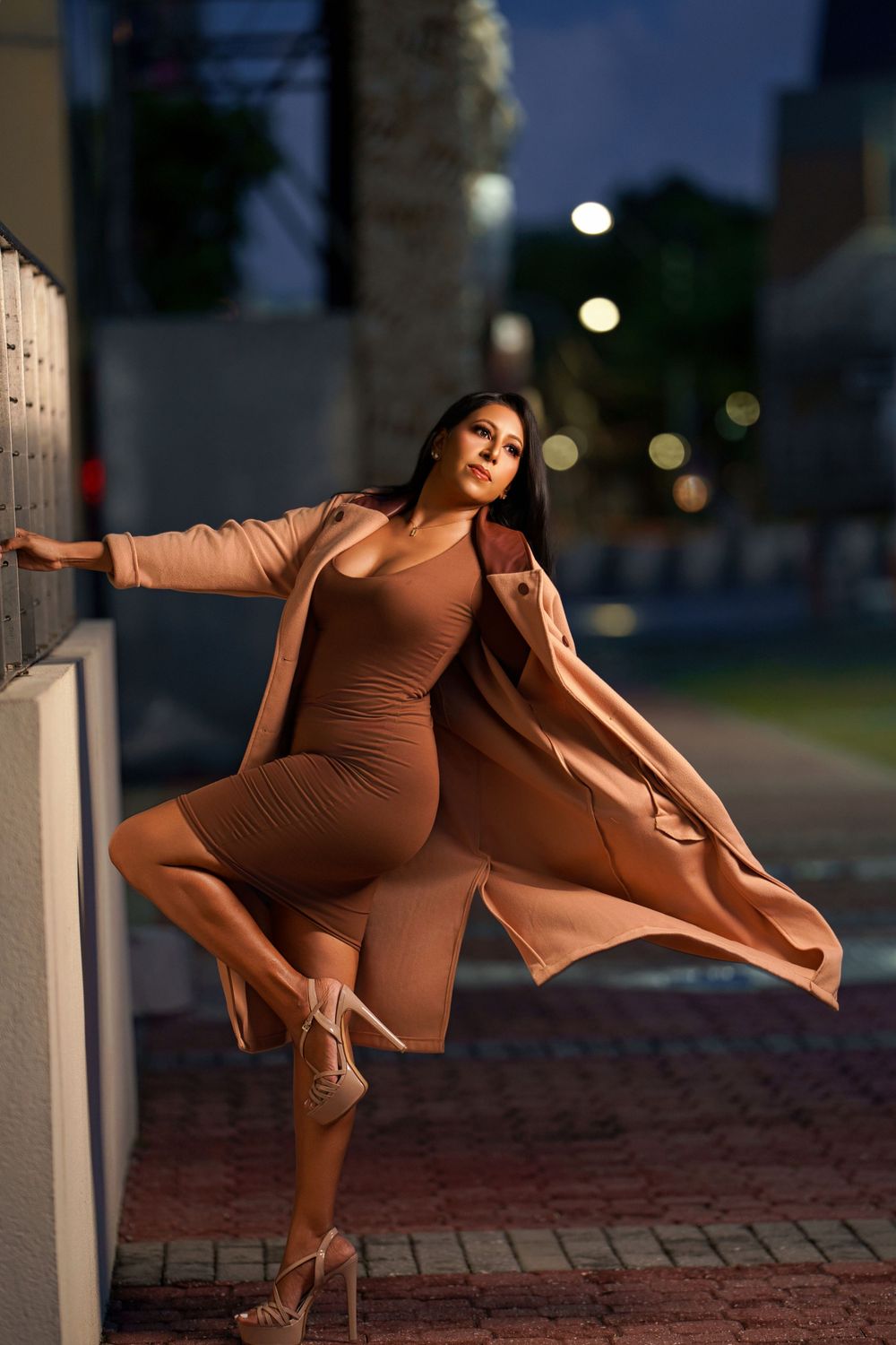 Dynamic fashion photography capturing flowing movement in neutral tones during dusk hours.