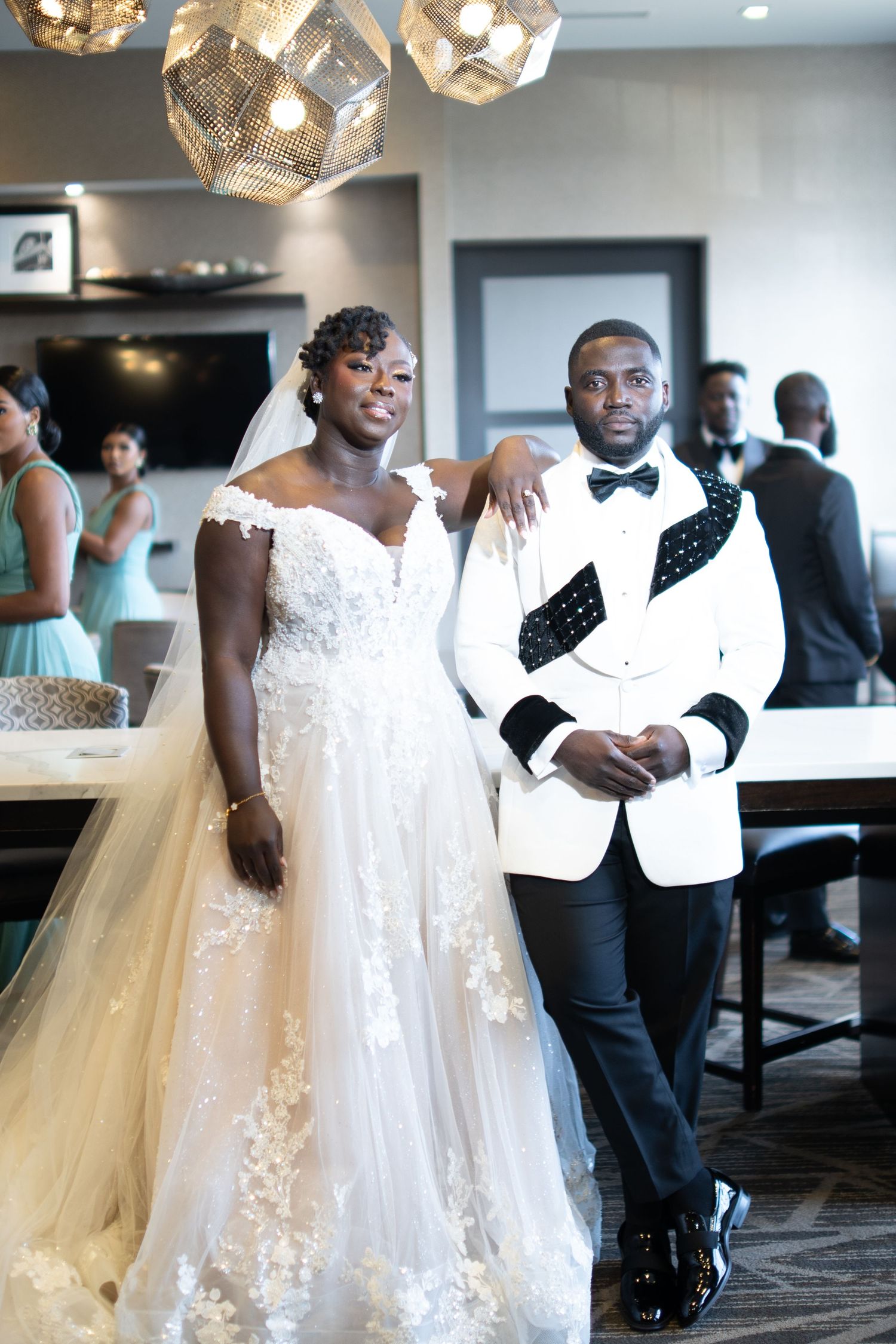 A wedding celebration shows a flowing white lace gown with tulle skirt during a reception dance.
