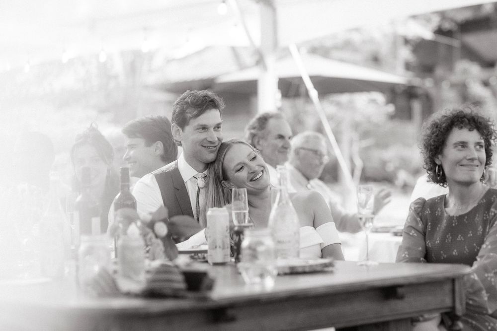Black and white photo of guests enjoying a festive outdoor celebration.