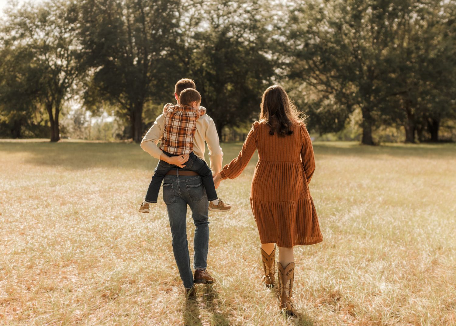 A joyful moment captured in a grassy field during a lifestyle photography session.