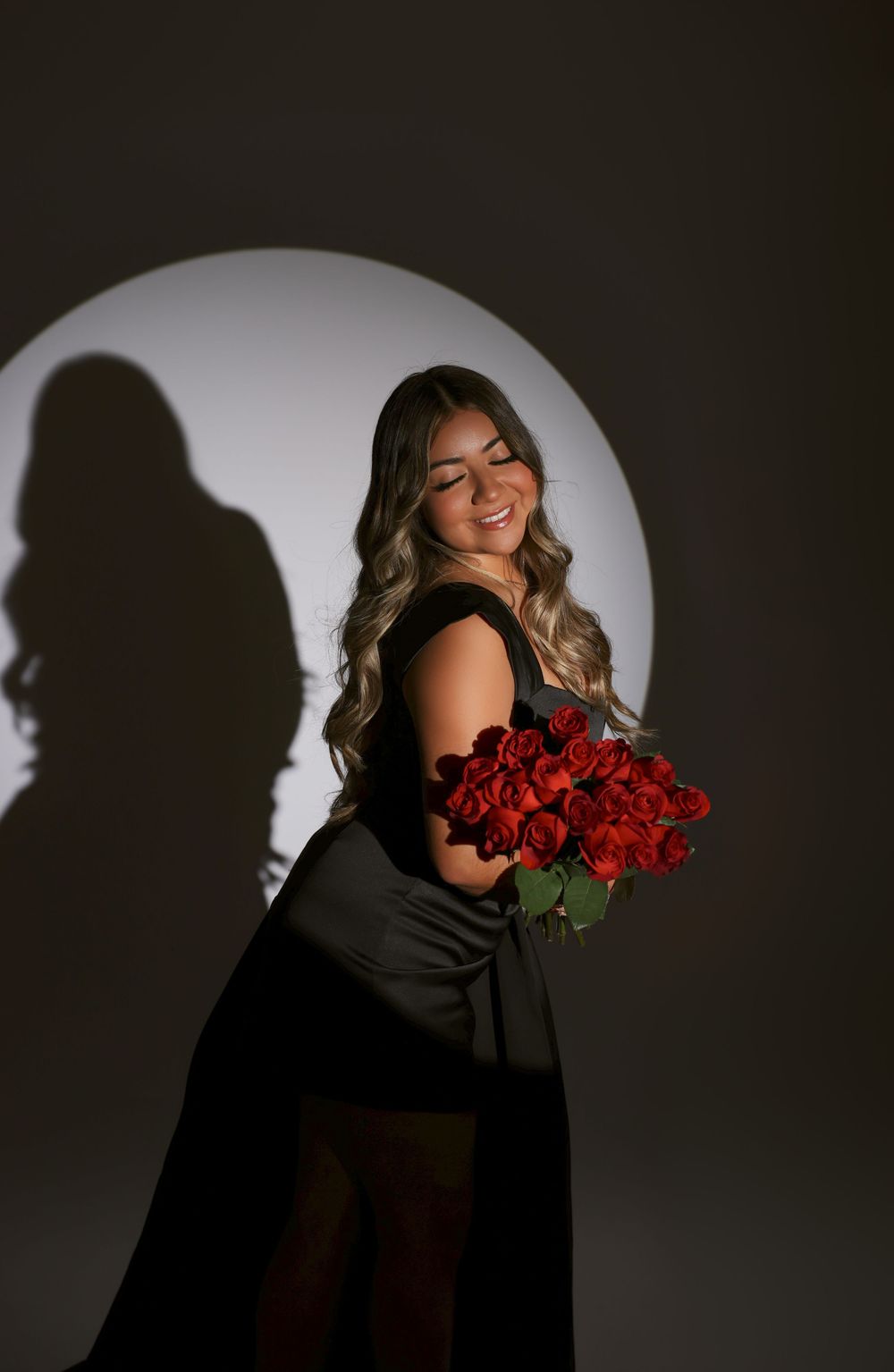 A dramatic photo series showing silhouettes against a white backdrop holding red roses with moody lighting effects.