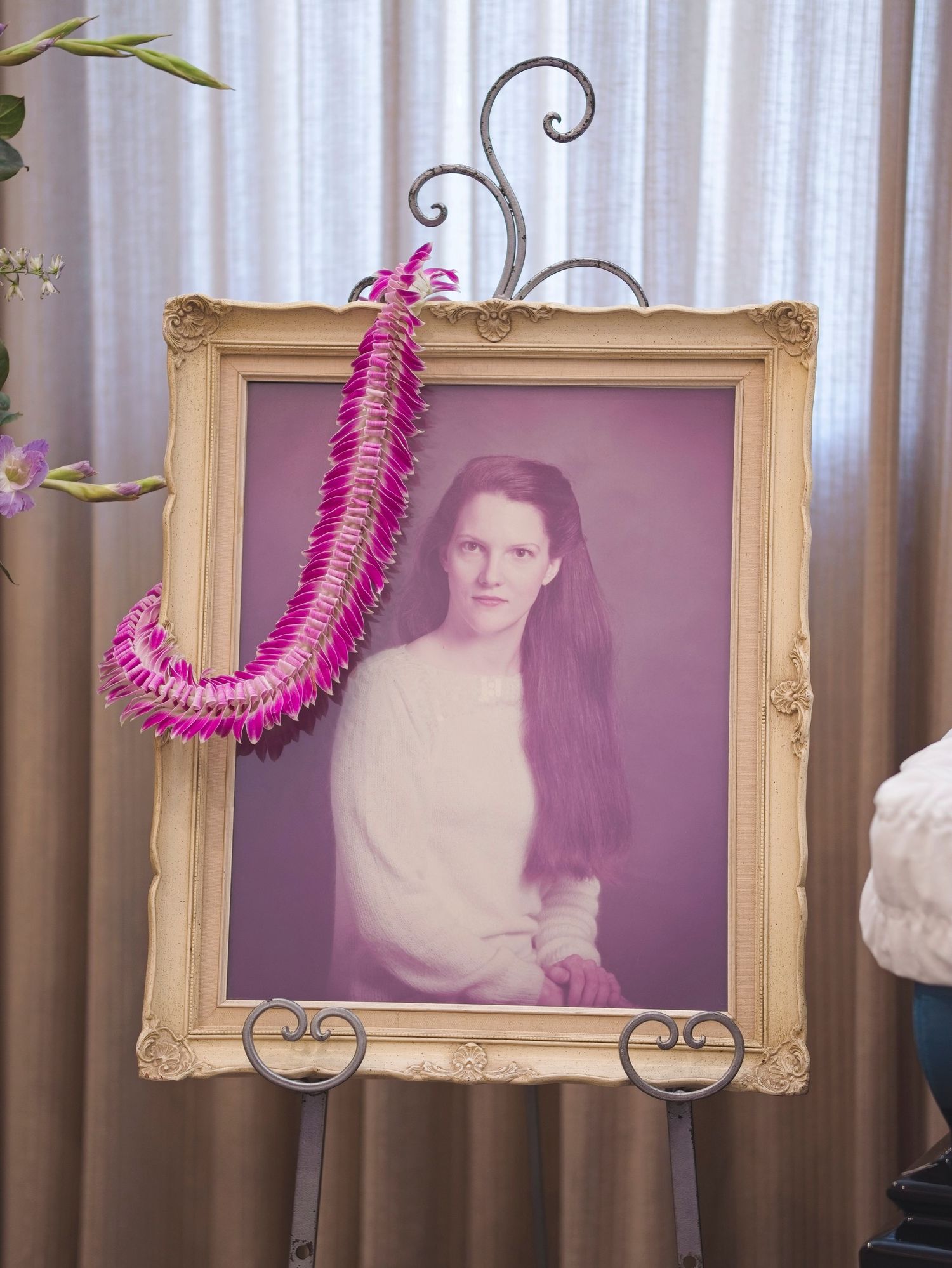 Framed photo with flower lay on a display stand
