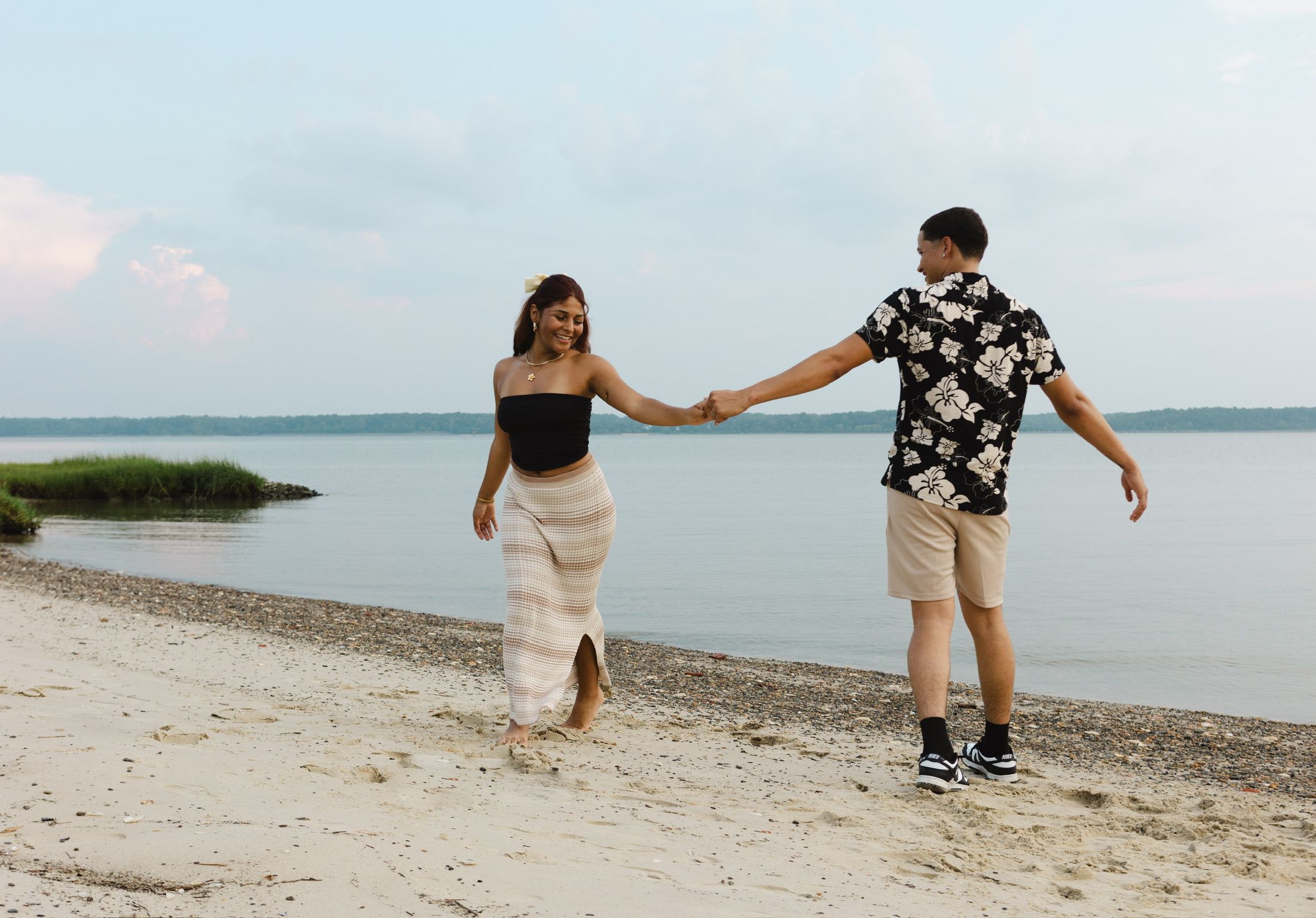 Latino couple holding hands on a local beach in Gloucester, Virginia