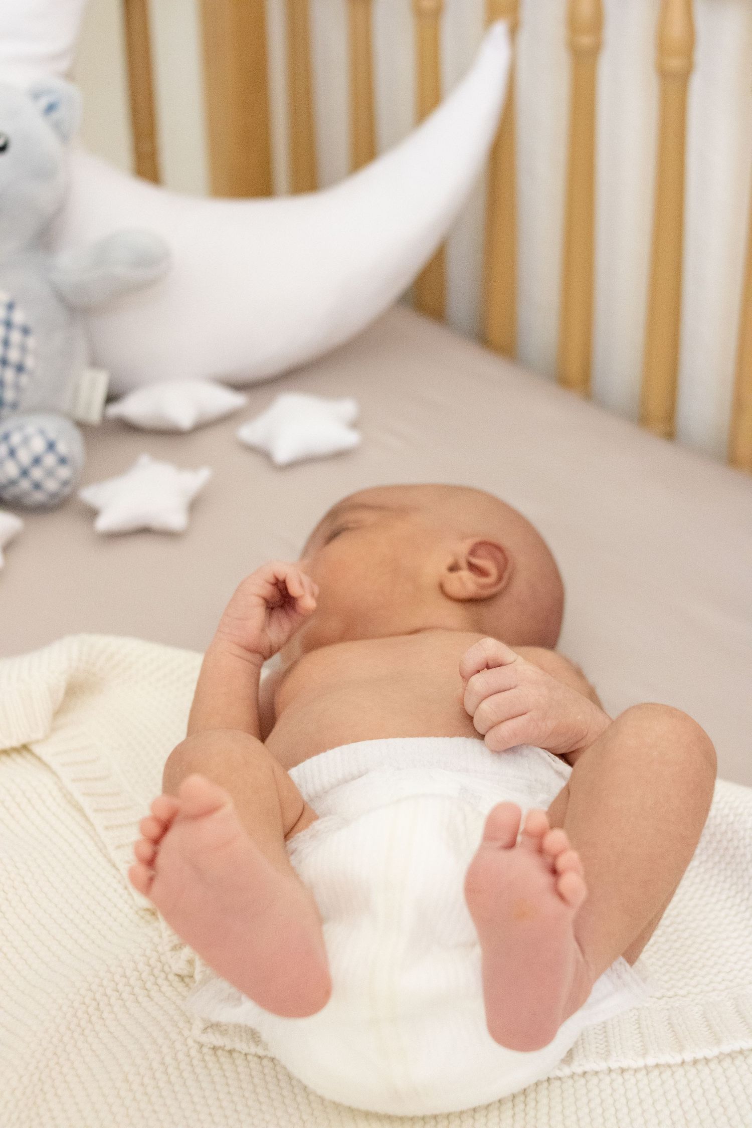 newborn baby laying in crib