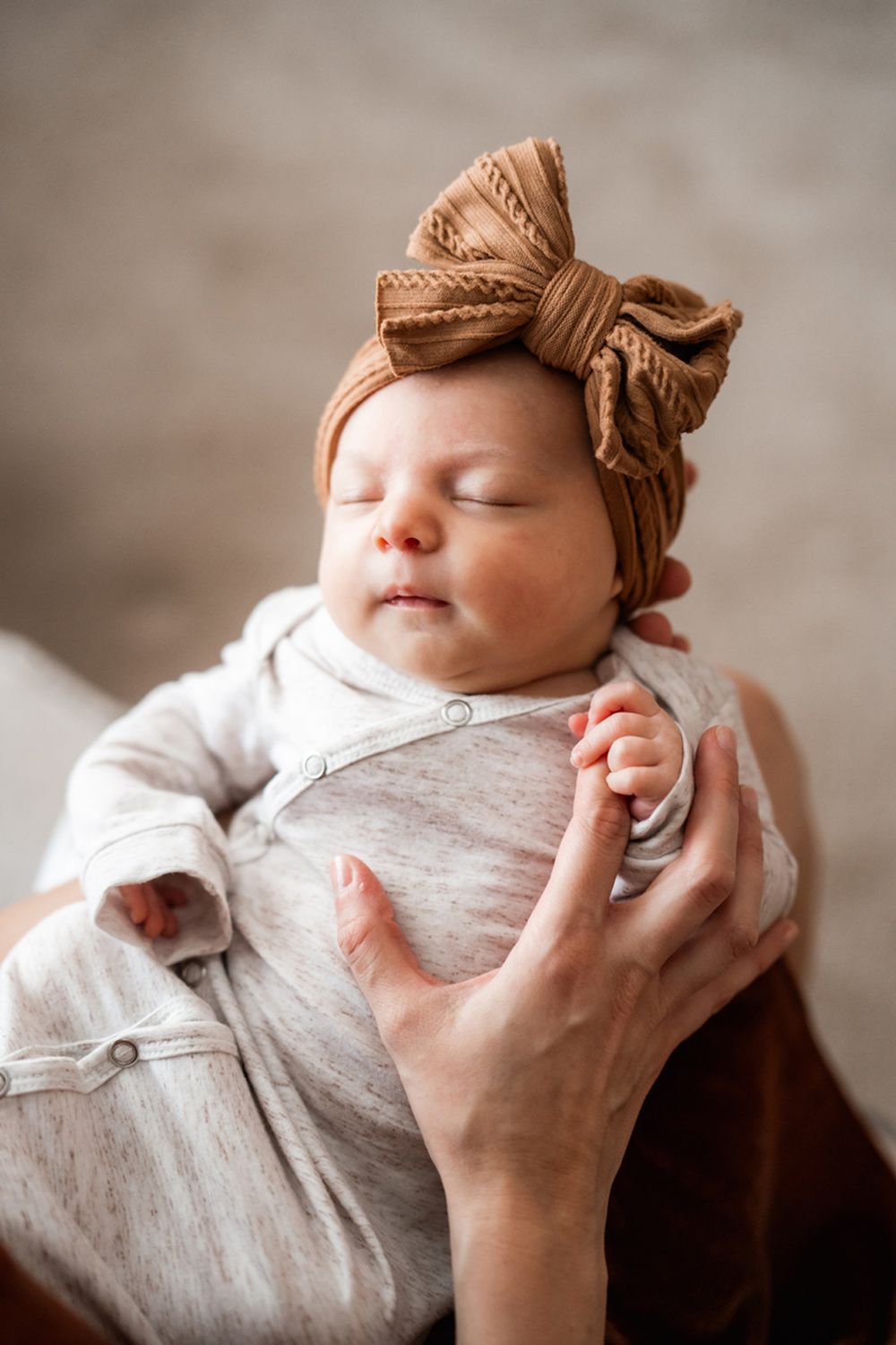 Newborn portrait of baby snuggled up at home.