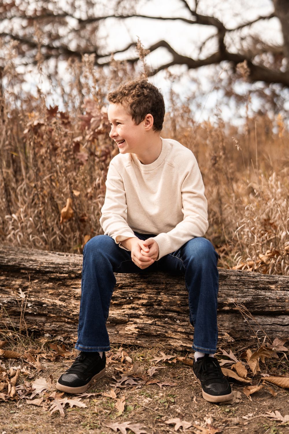 November portrait of boy in forest in Oak Brook, Illinois.