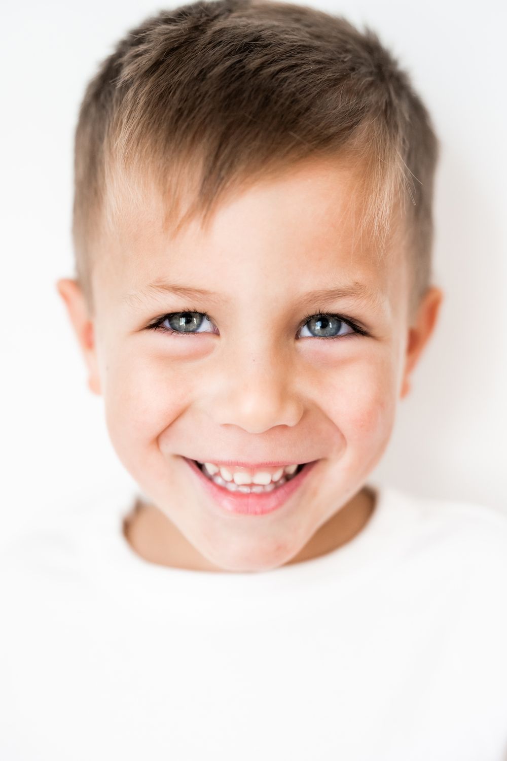 High key portrait of boy during family session at home in Hinsdale, Illinois.