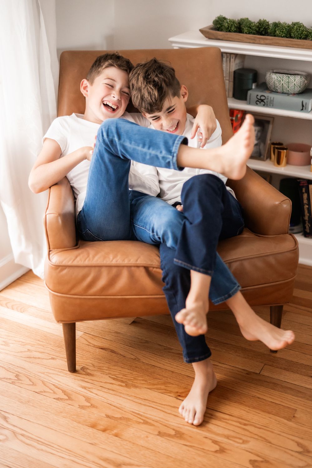 Boys laughing together and having fun during at home family portrait session in Hinsdale, Illinois.