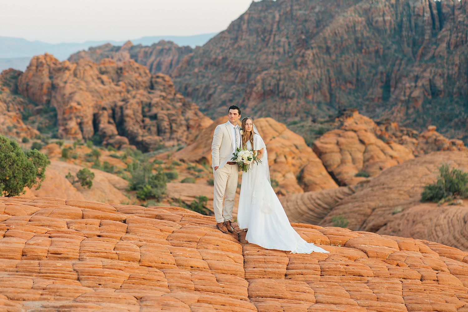 Romantic desert photoshoot among dramatic red rock formations and cliffs in Utah's wilderness.