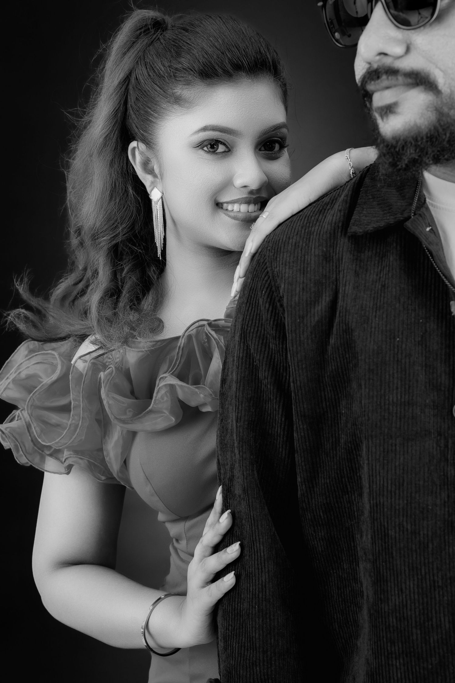 Black and white portrait series showing tender moments between a couple in romantic poses.