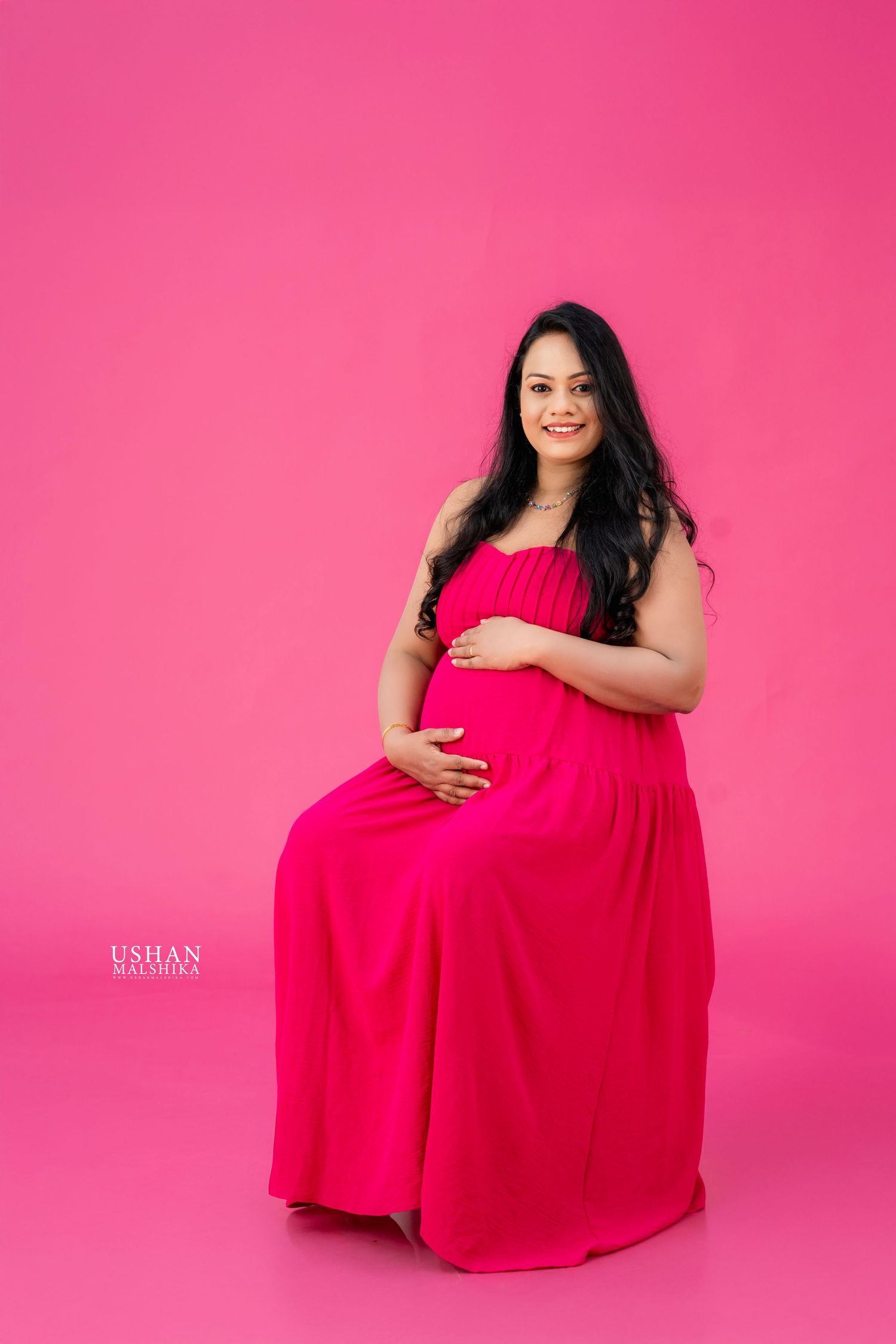 Maternity photo series showing person in red dress against pink background in four artistic poses.