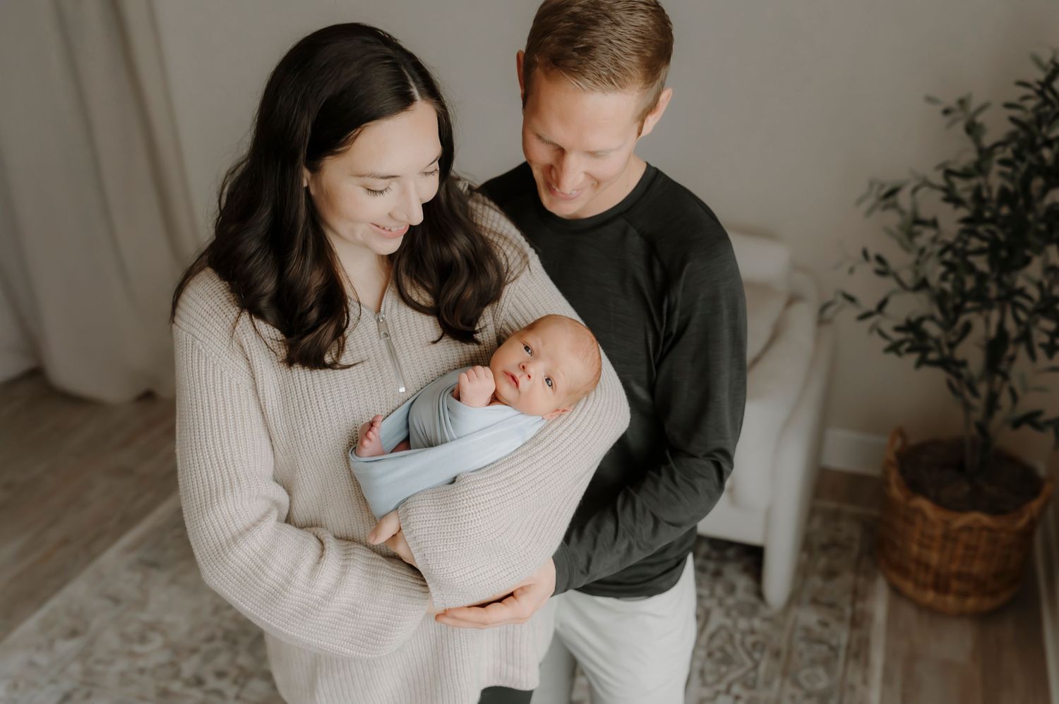 Intimate family portrait session in minimalist setting with natural window light.