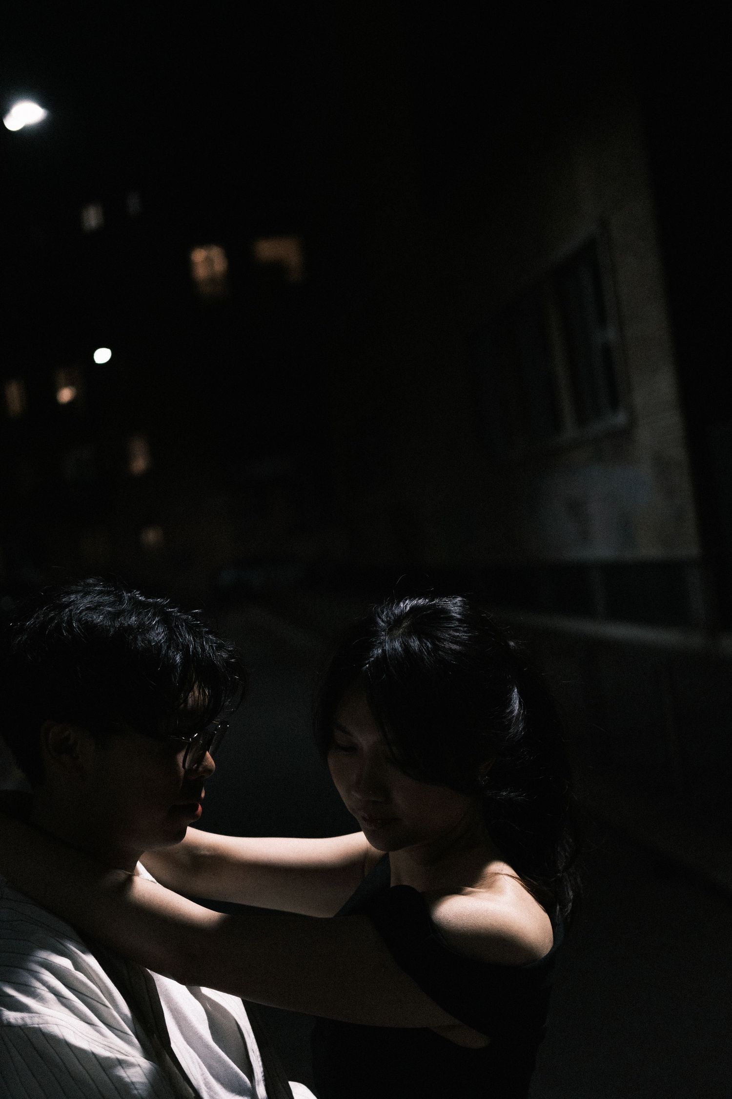 A dark artistic portrait series showing silhouetted figures against dramatic lighting in a moody black background.