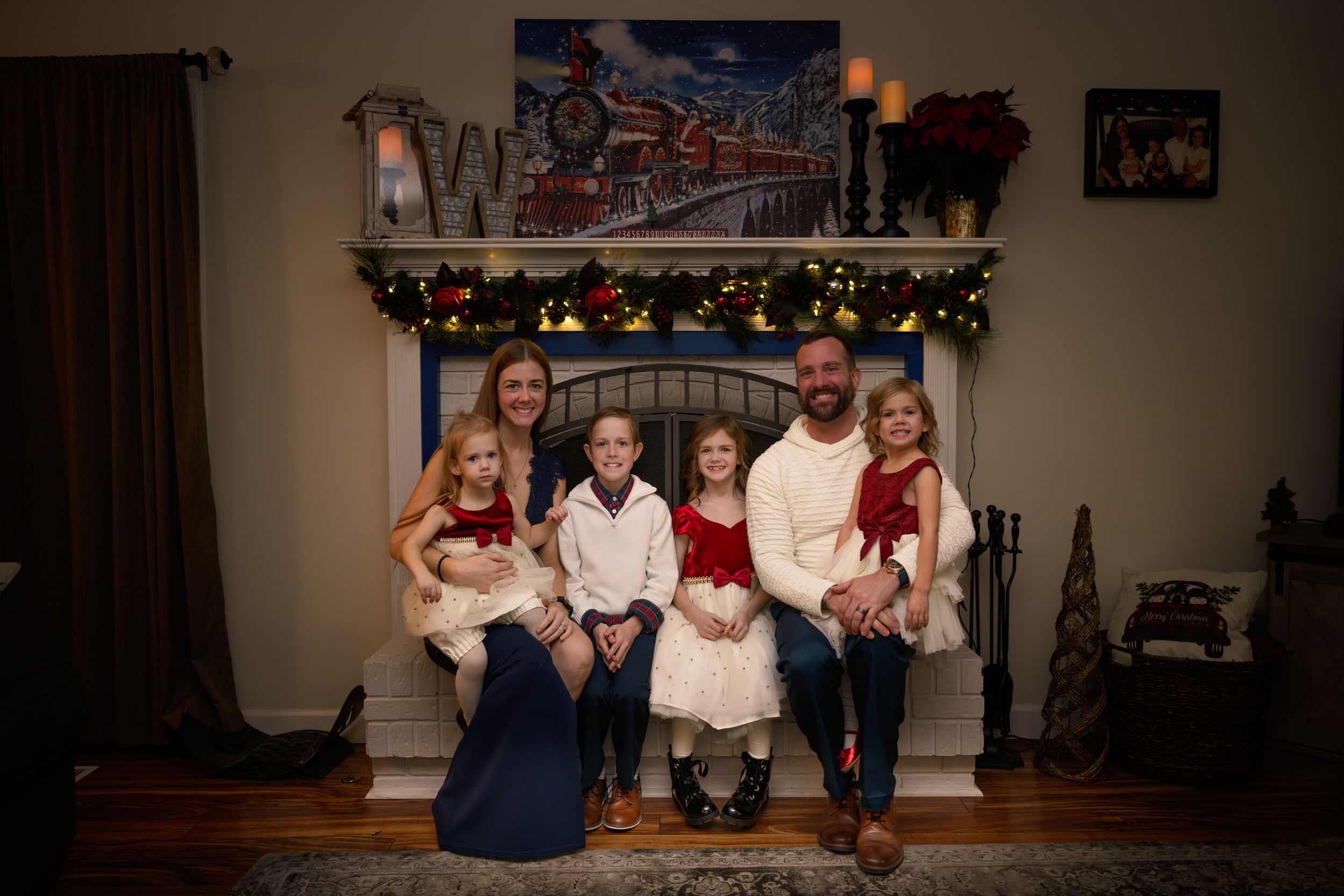 family sitting by the fireplace