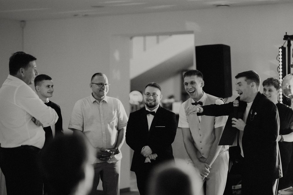 Black and white photo of a group gathered for speeches during a celebration event.