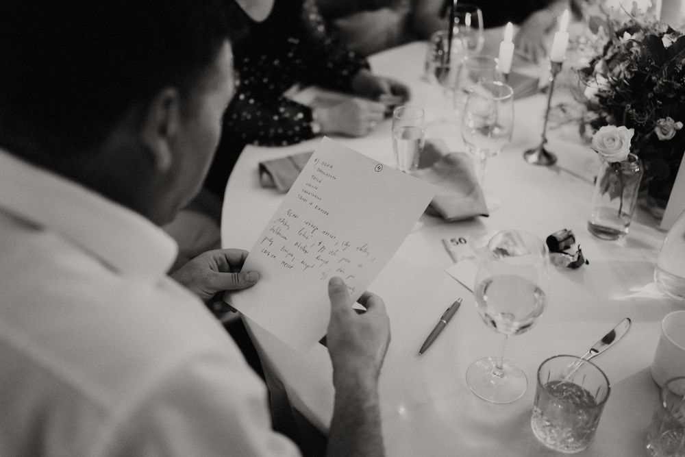 Black and white photo of elegant table settings at a formal wedding reception.