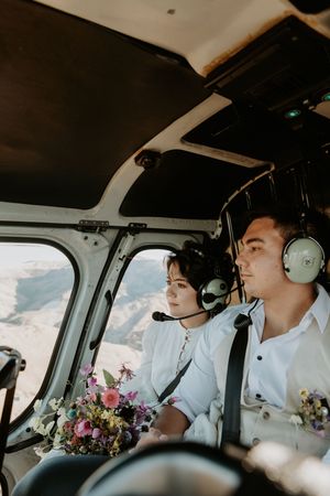 bride & groom in helicopter, luxury wedding photographer Christchurch