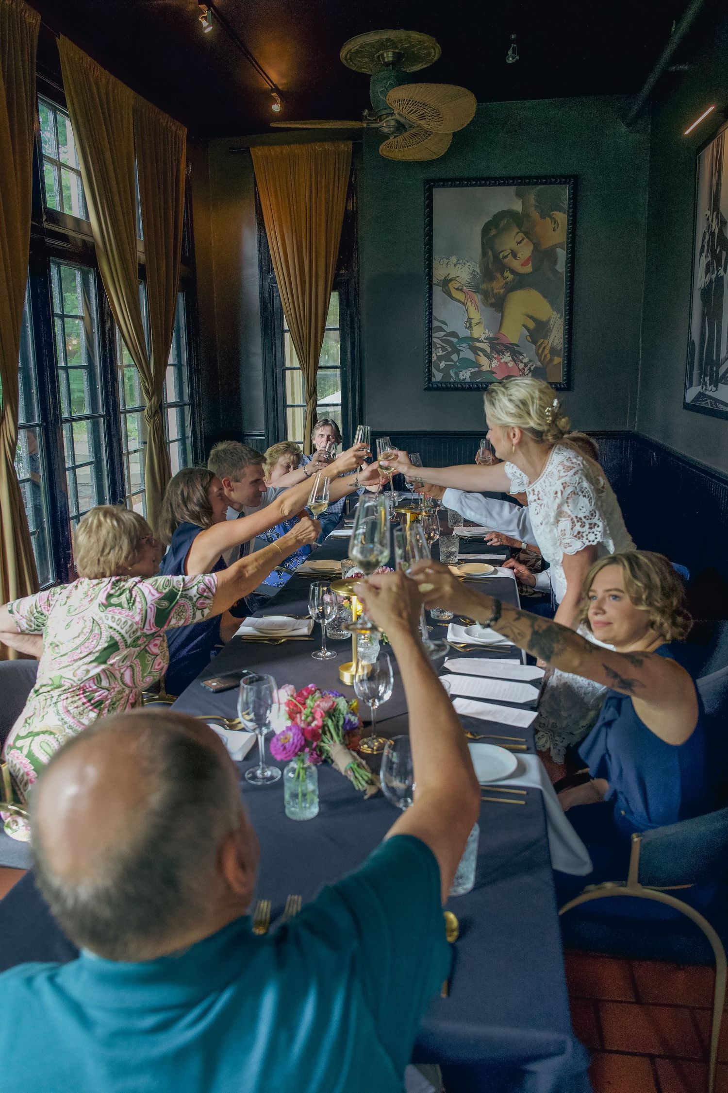 A group of people sitting at a table drinking beverages together in a restaurant setting.