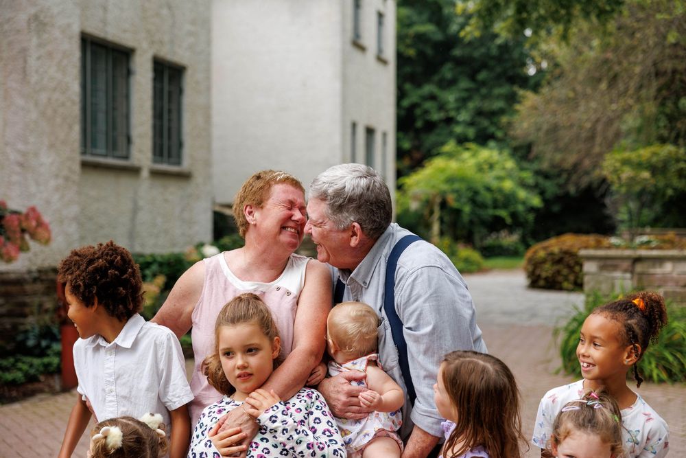 A series of candid wedding photos showing joyful moments and interactions between guests at an outdoor celebration.