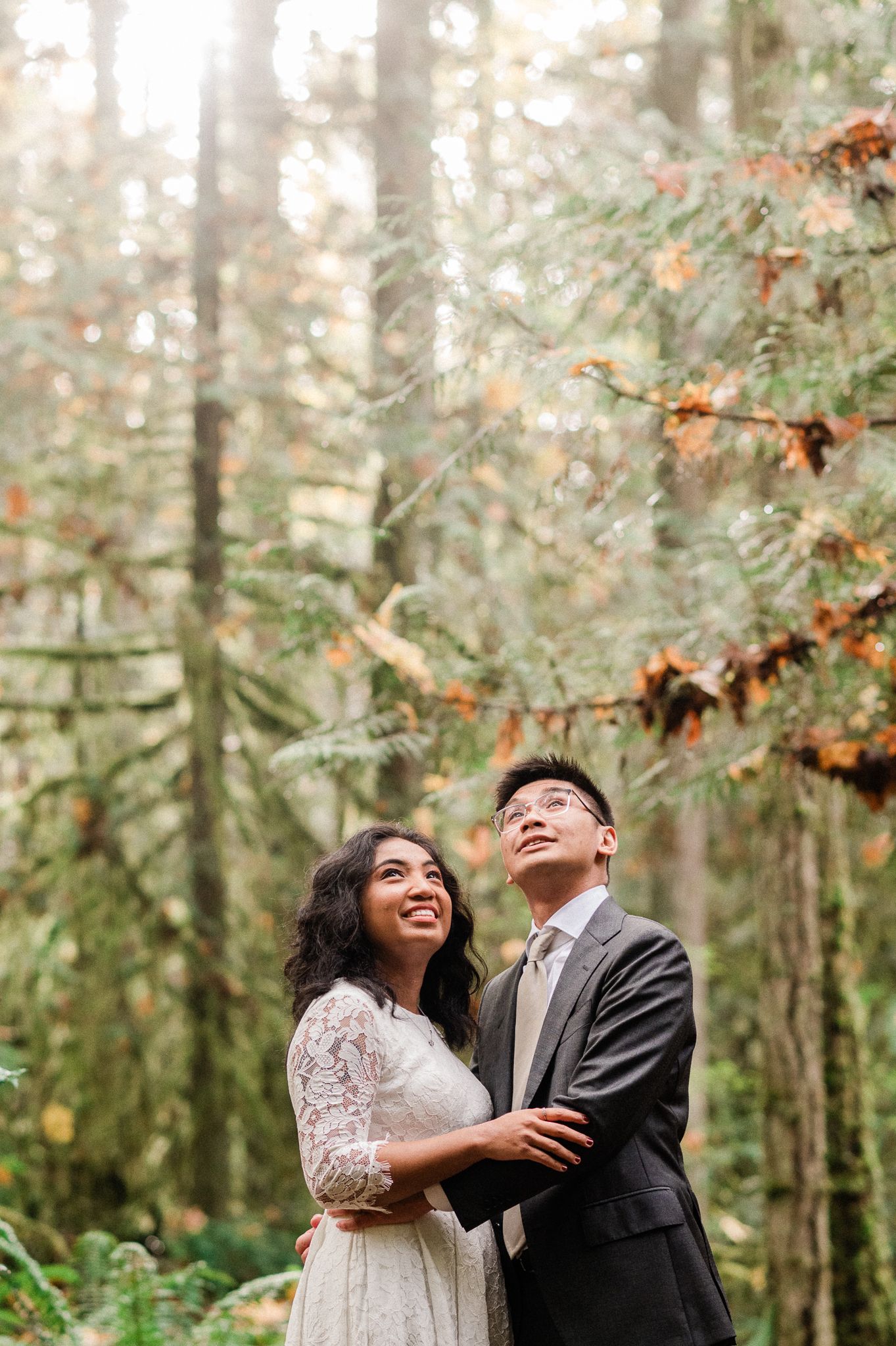 A couple dancing together in a misty forest setting with autumn foliage during their Bainbridge Island Elopement in the Grand Forest West