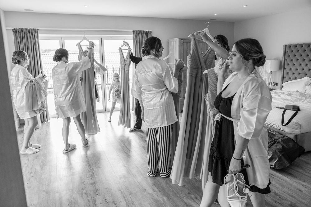 Wedding party preparations captured in black and white panoramic shot.