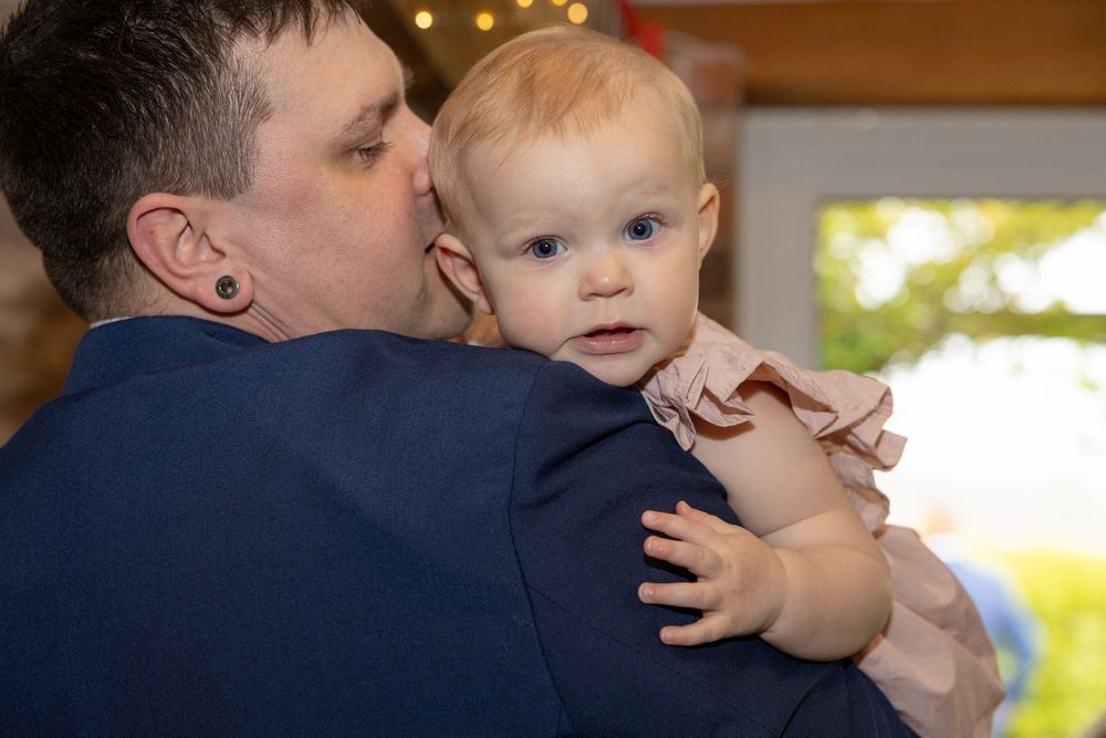 Tender family moments captured during wedding celebrations with soft lighting.