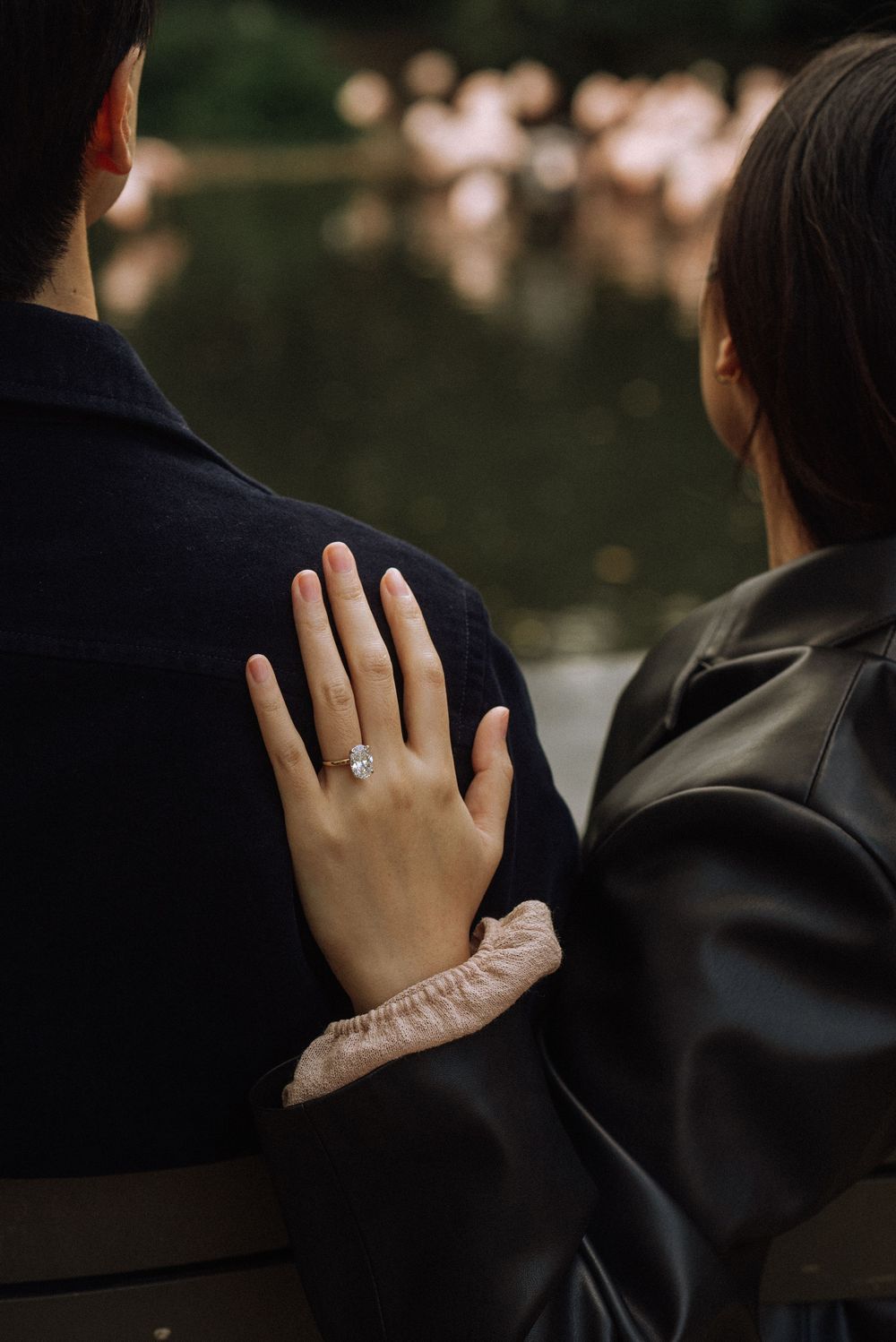 A close-up series of a hand wearing an engagement ring, showing the ring from different angles in dark lighting.
