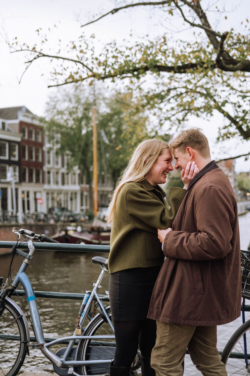 A romantic autumn moment by an Amsterdam canal with bicycles parked along the waterfront.
