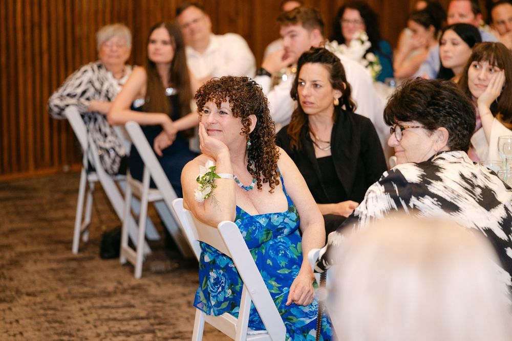 Wedding celebration showing guests seated at tables during an indoor reception.