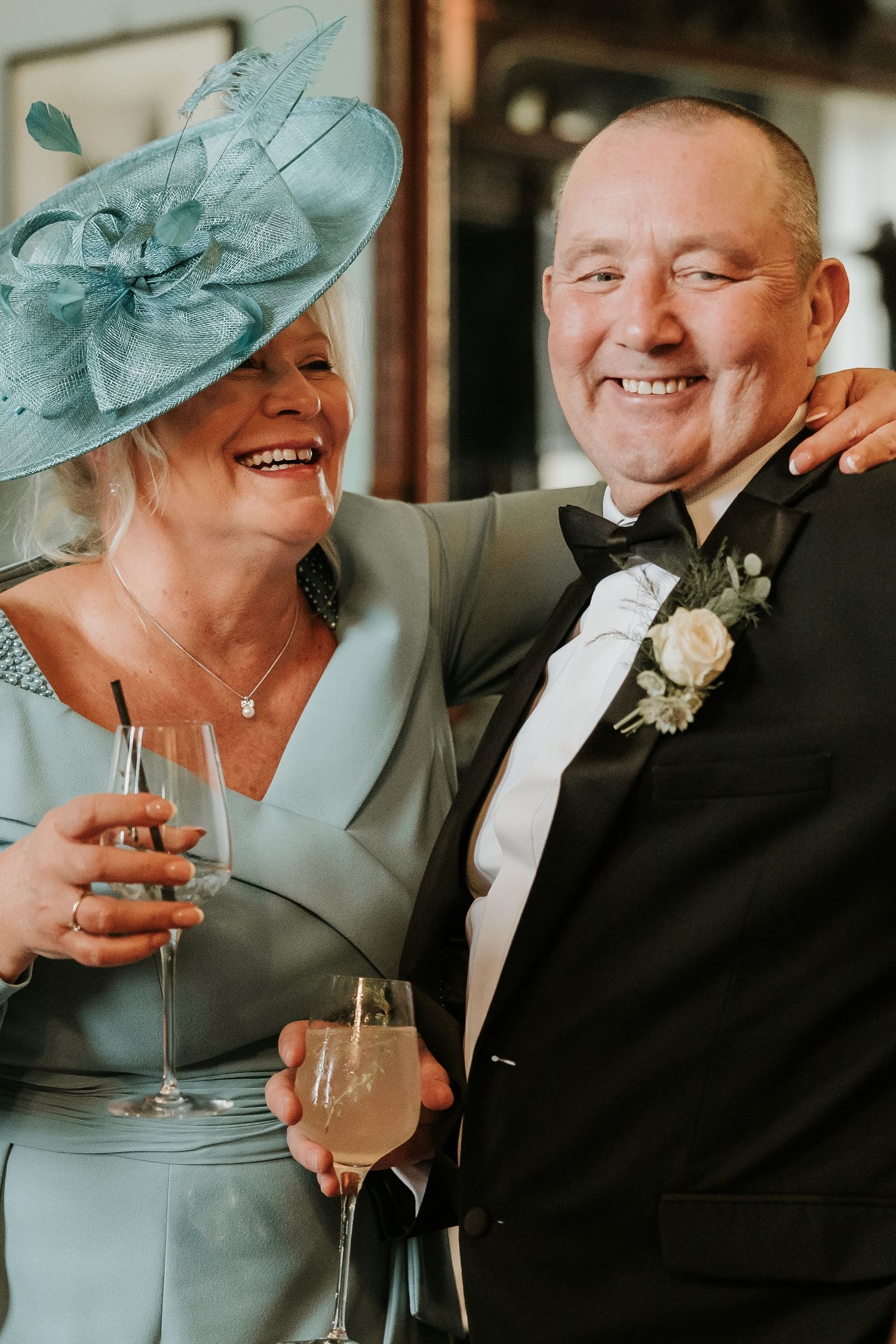 Sequence of candid wedding photos showing couple sharing laughter and champagne while wearing formal attire.