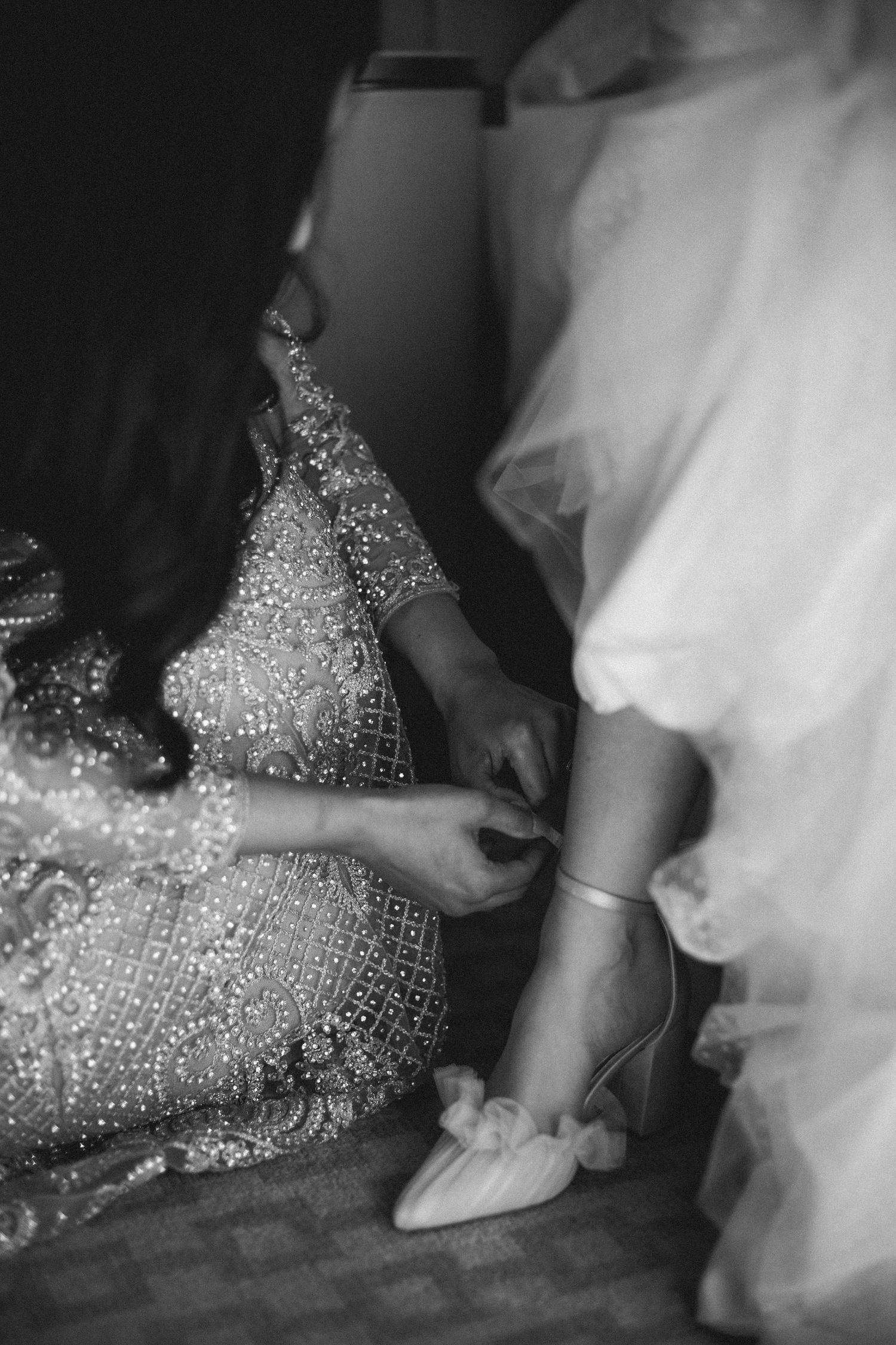 Black and white image of sparkly dress and ballet flats being put on during wedding preparations at The Lord Nelson, Halifax