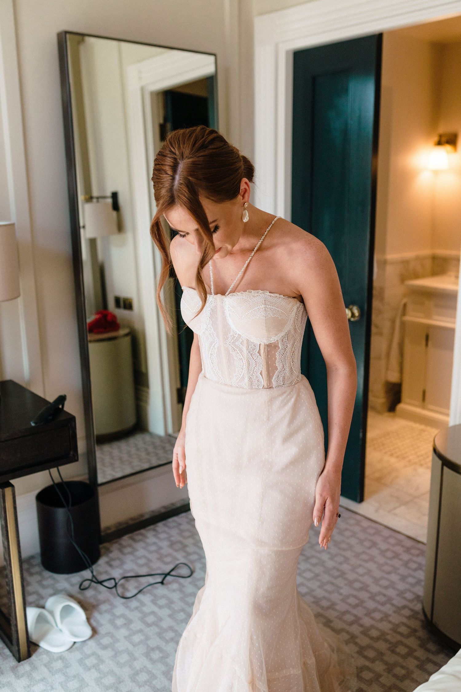 A stunning form-fitting wedding dress with delicate lace details shown in a bridal suite at The Lord Nelson, Halifax.