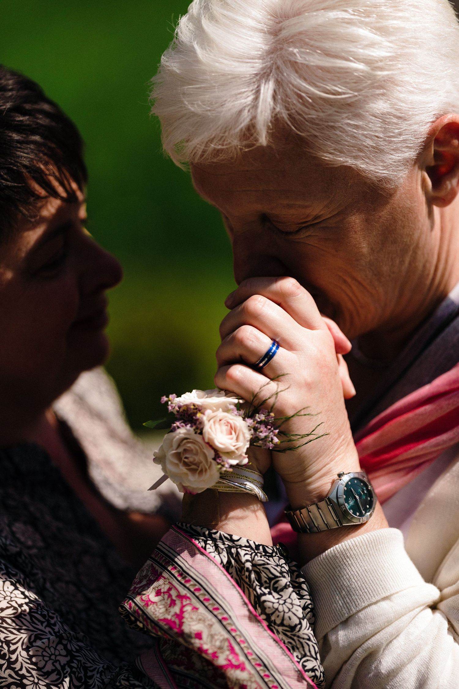 A tender moment captured with white roses and jewelry details in warm sunlight as LGBTQ couple dance near The Lord Nelson, Halifax venue