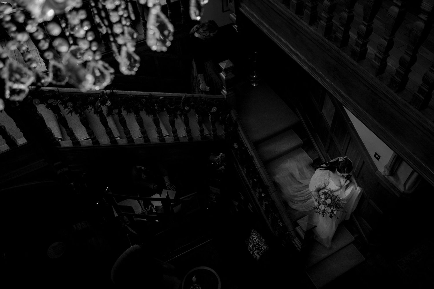 A dark black and white aerial view of ornate crystal chandeliers hanging in a dimly lit interior space at The Lord Nelson, Halifax