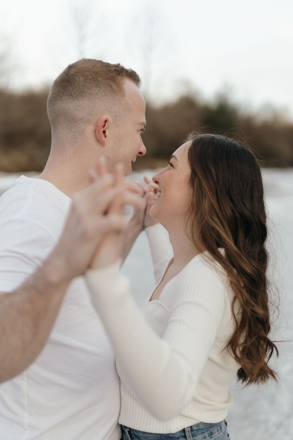 Romantic couple sharing intimate moment on frozen lake.