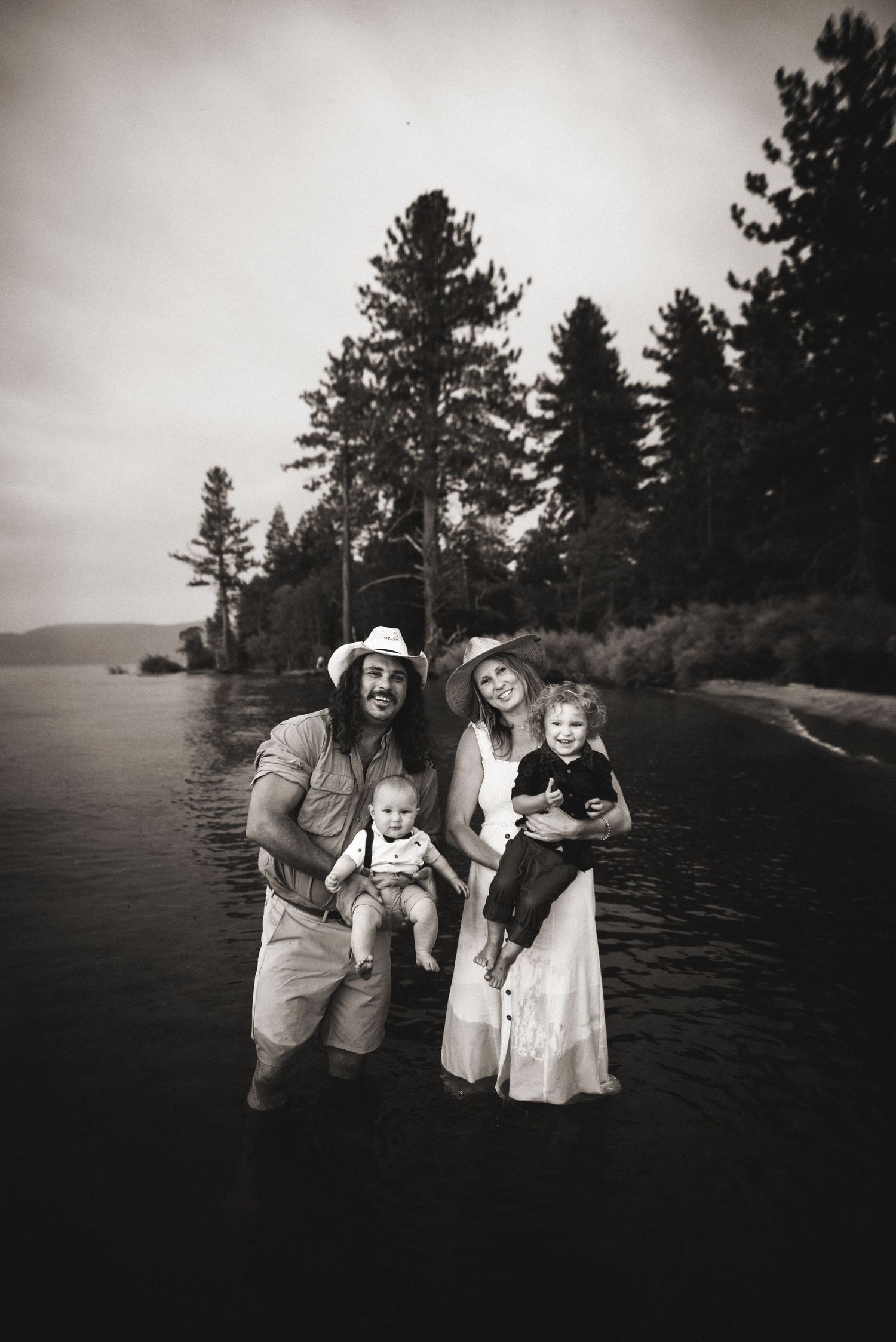 Tahoe family photo session at sunset with parents and children laughing in golden light, captured by Alicia Alvey Photography.