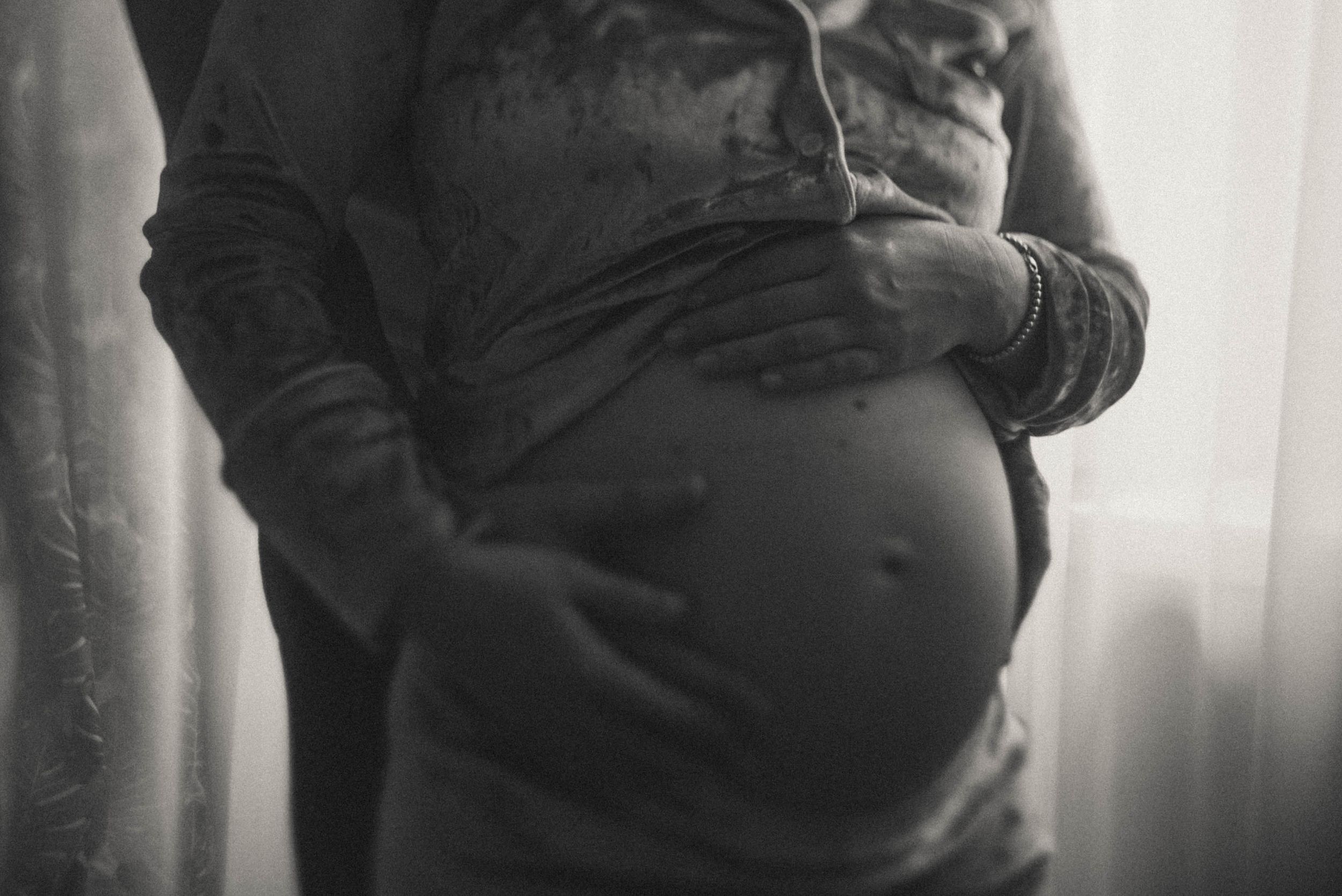 Series of maternity silhouettes showing pregnancy progression in monochromatic tones.
