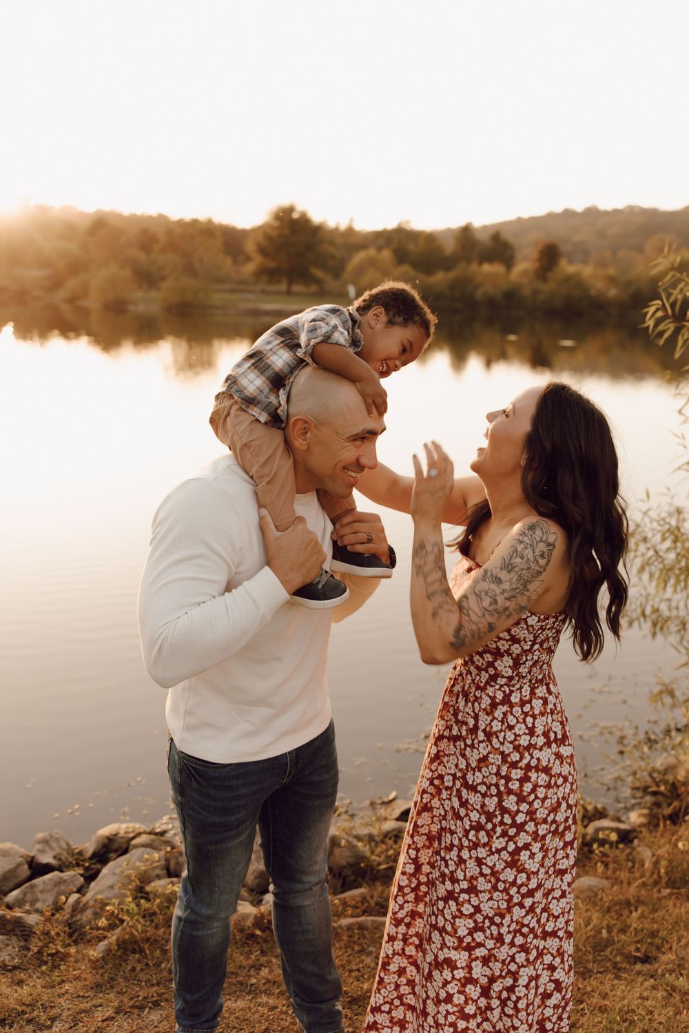 Casual family photo session with parents and children, captured in a lush park setting.