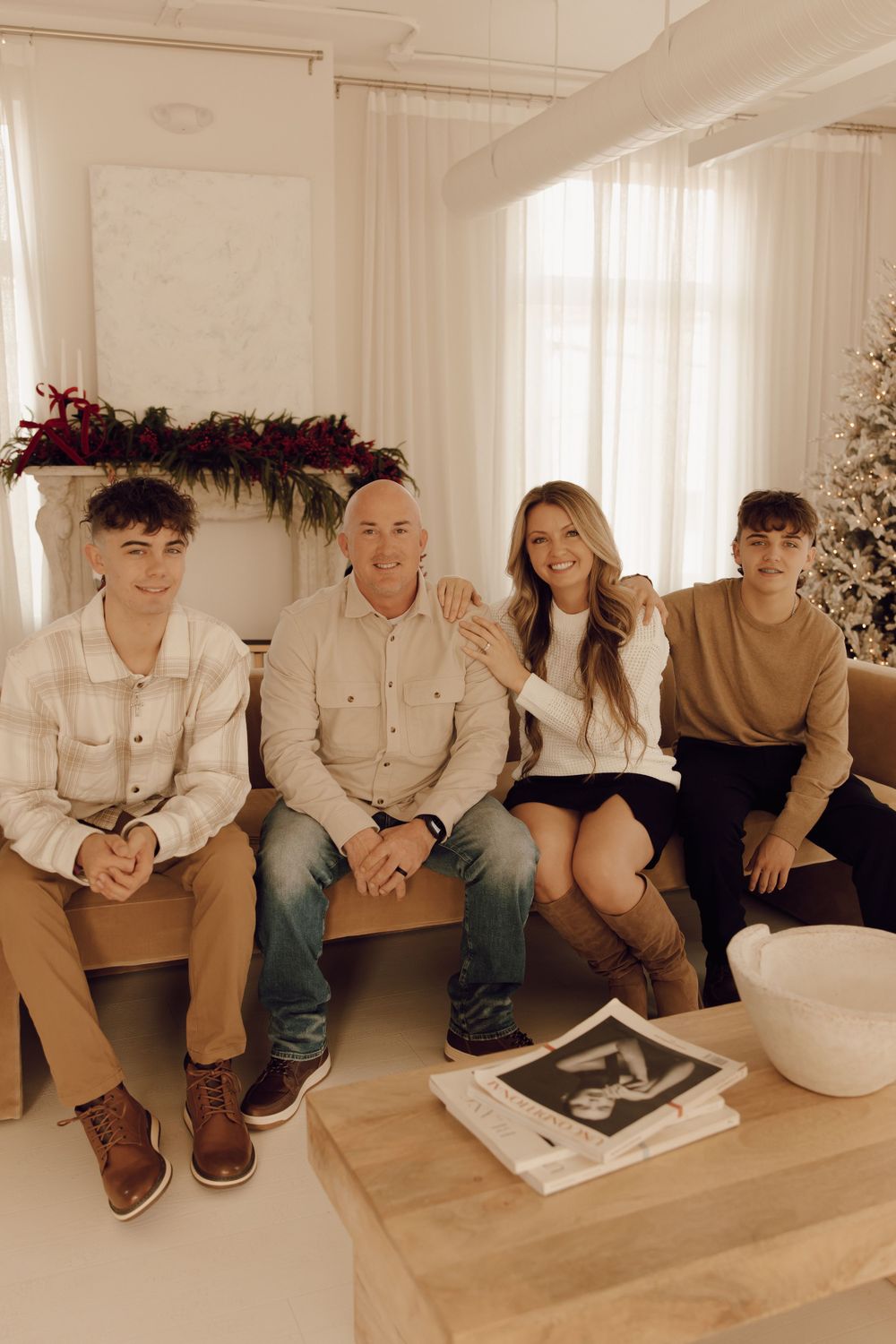 Casual family photo session with parents and children, captured in a lush park setting.