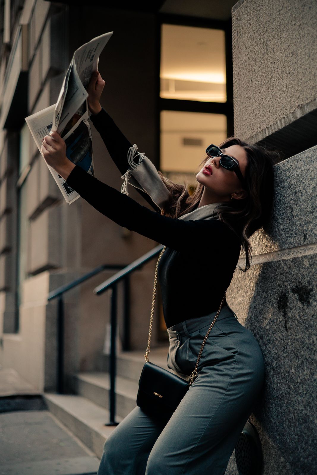 Cinematic portrait of woman in Miami holding newspaper in a fashion-inspired editorial pose — lifestyle photography by Mannyportraits.