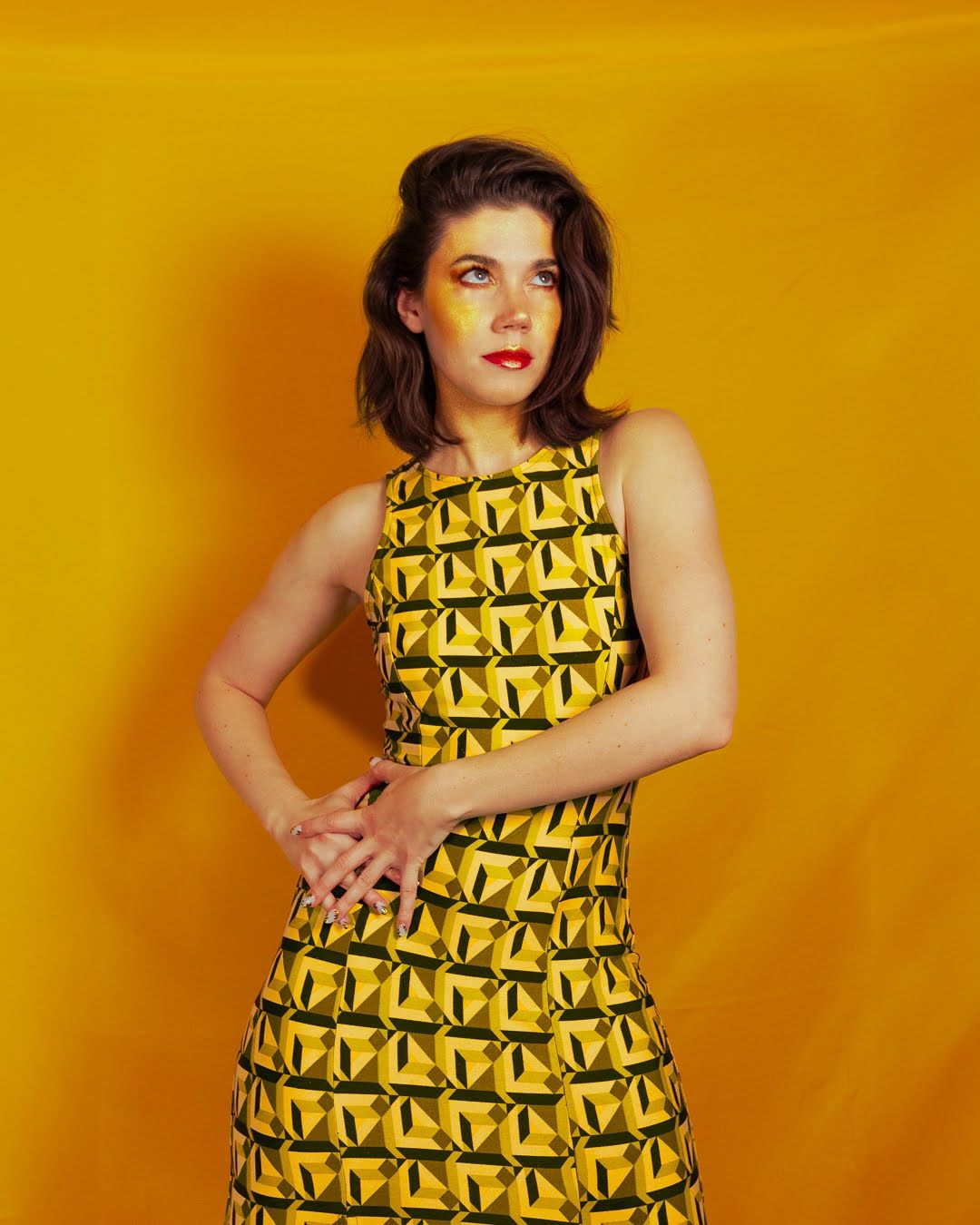Jessie Thiele Photography : portrait of Jessie Thiele in a yellow dress against a yellow backdrop
