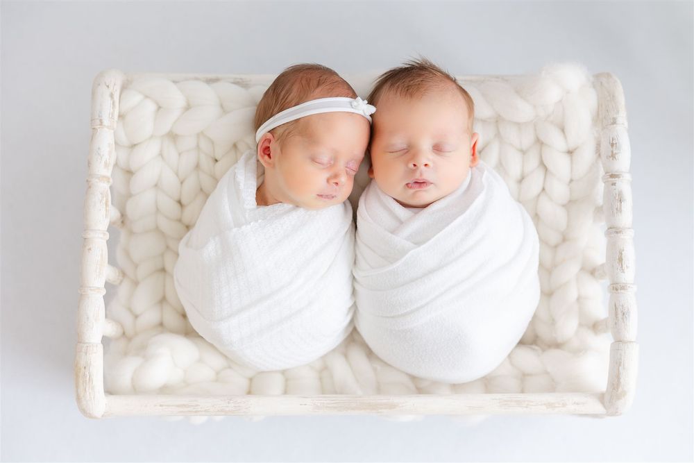 twin babies in white
