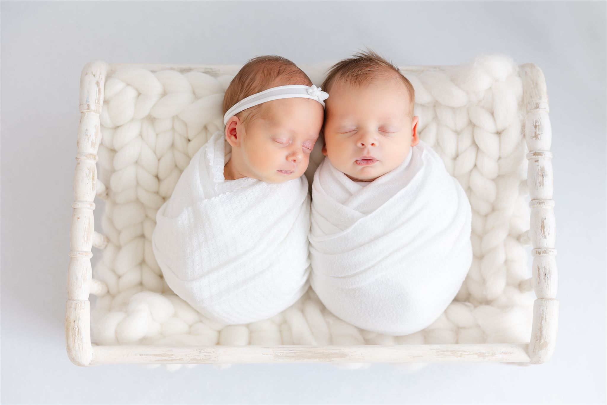 twin babies in white