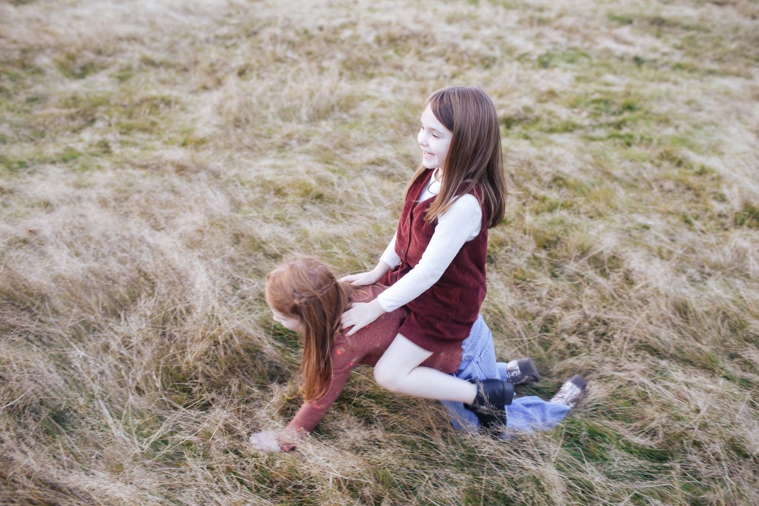 Everett WA family photographer: two sisters play with each other at Wayne Park Golf Course in Bothell WA