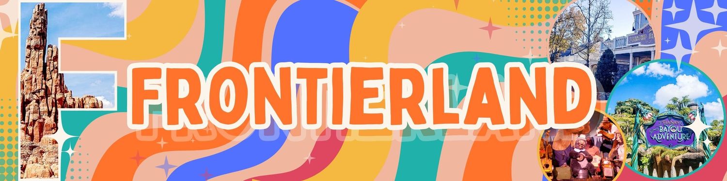 Colorful retro-style Frontierland sign with bright orange and blue swirls against a theme park backdrop.