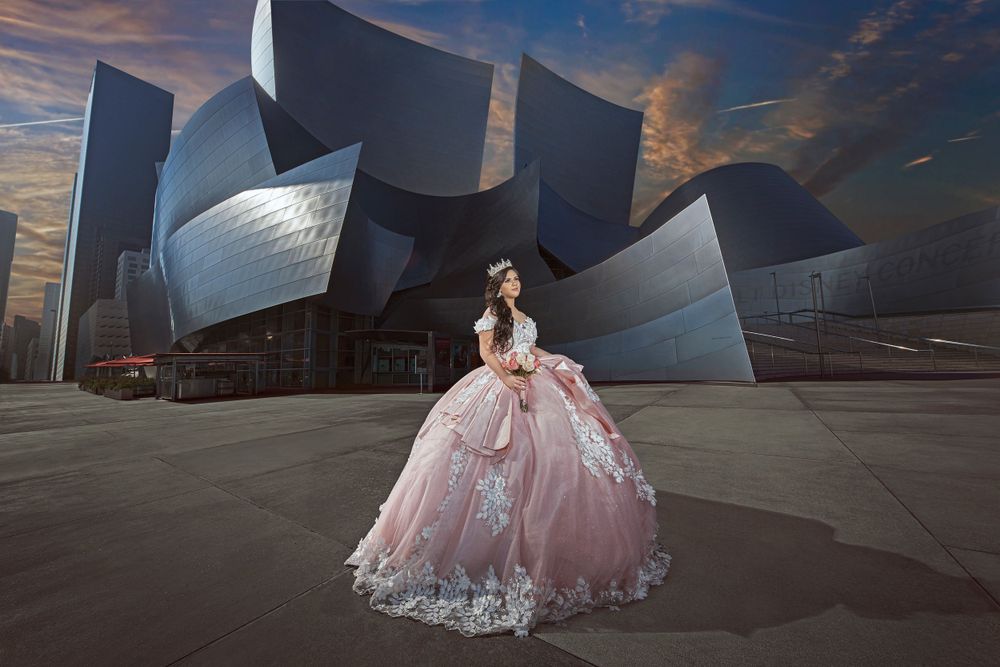 A stunning pink ballgown photographed against the modern architecture of Walt Disney Concert Hall at sunset.