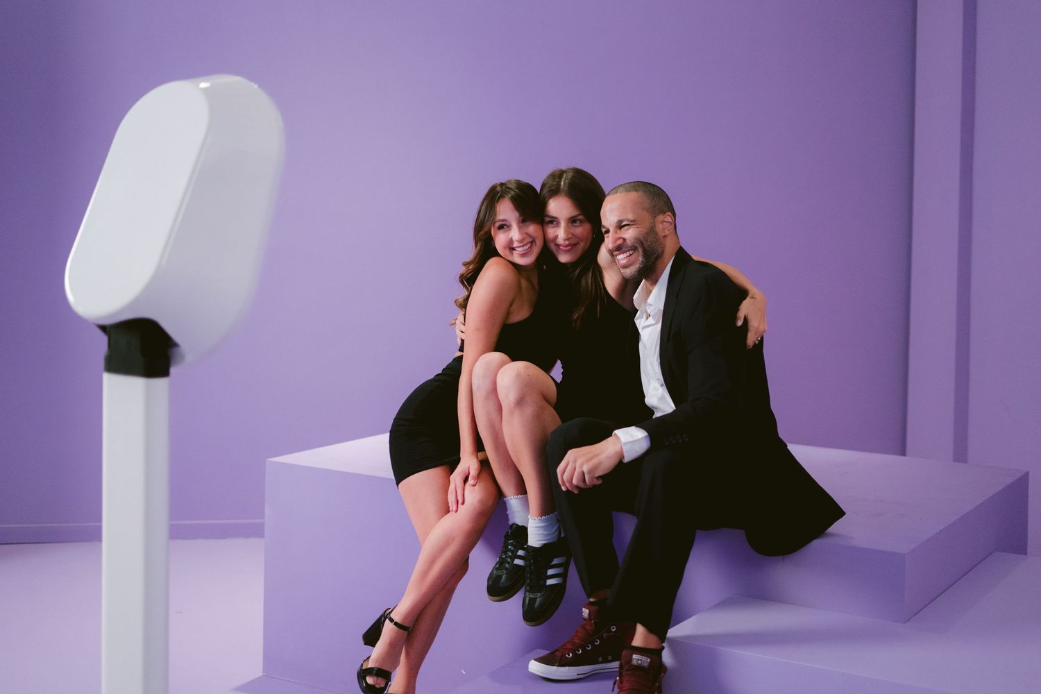 Happy group posing in front of the photo booth, capturing fun and memorable moments at the event!