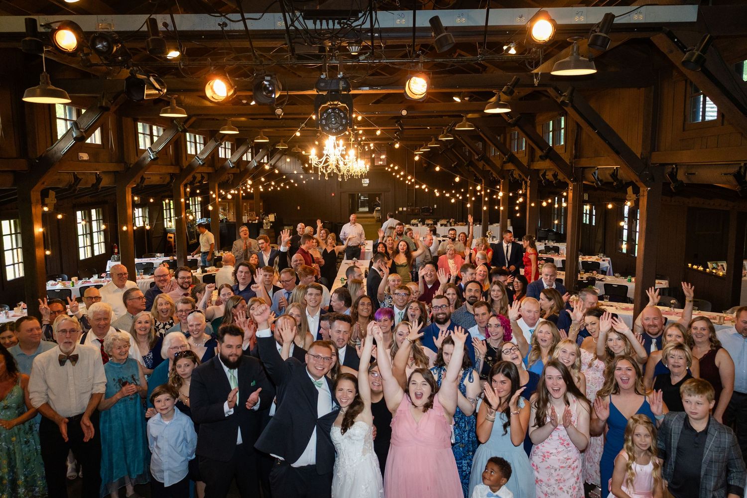 Wedding guests form a sparkler tunnel to celebrate the newlyweds making their grand exit at an evening reception.