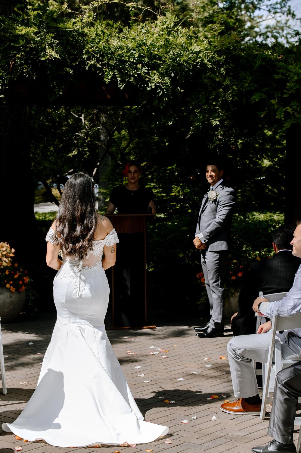 A sequence of wedding proposal shots on a brick patio shows a couple during an intimate outdoor surprise moment.